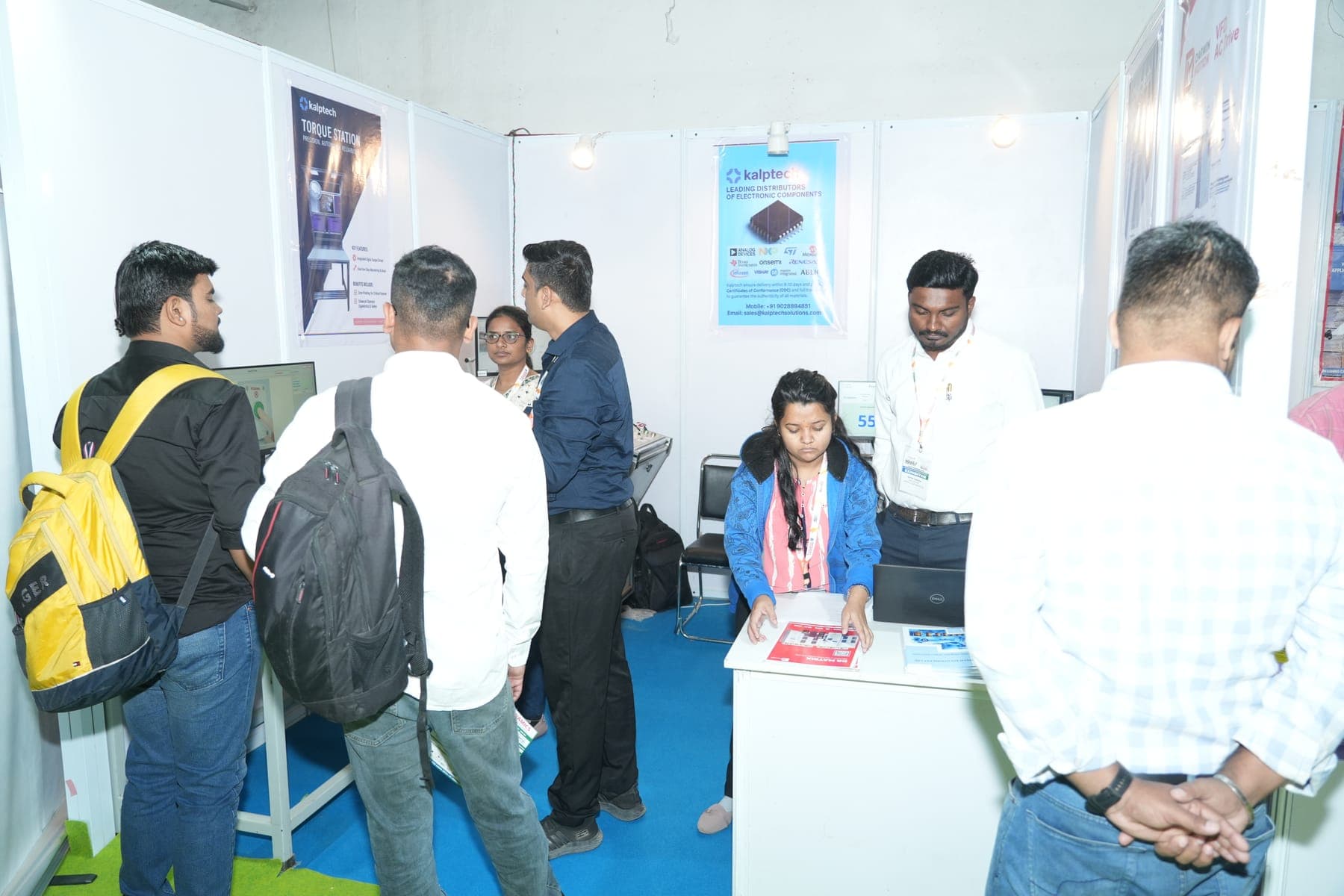Visitors engaging with an exhibitor at a components booth at a previous edition