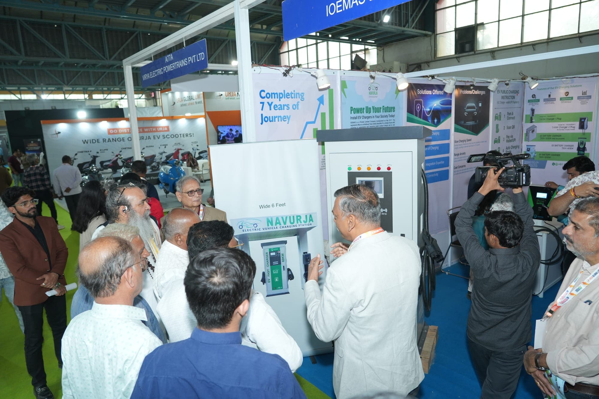 Visitors gathered around an EV charging station display at a previous edition